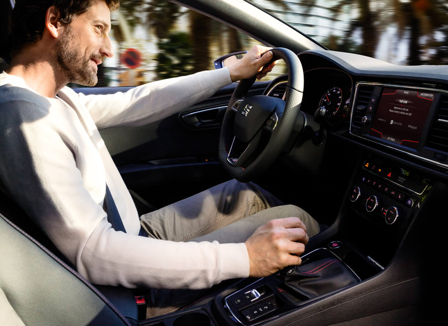 SEAT new car services and maintenance – interior view of a man driving a SEAT new car